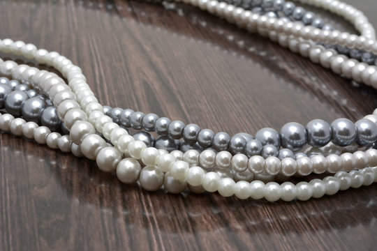 Strings of pearl beads on dark background
