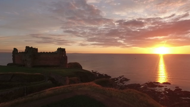 Stunning aerial shot Tantallon Castle off the coast of North Berick, Scotland with Bass rock in the background
