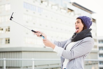 Happy woman using selfie stick - Powered by Adobe