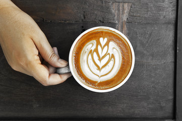 a cup of latte art coffee take with selective color technique and art lighting