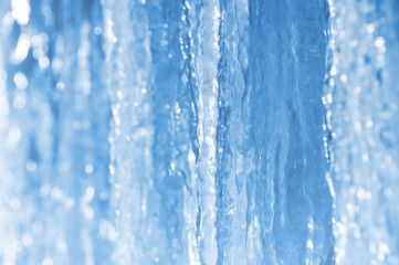 Bright spring background with icicles in the sunlight