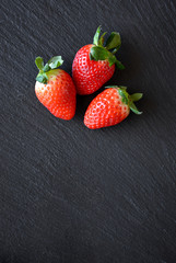 Strawberries on a black slate table