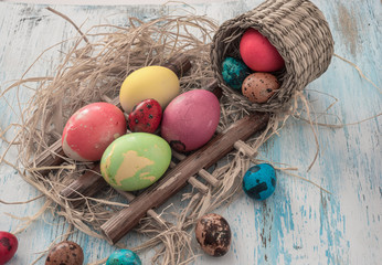 Happy Easter multi-colored eggs on wooden bacground