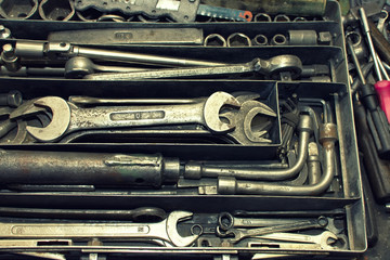 Dirty set of hand tools on a vintage background