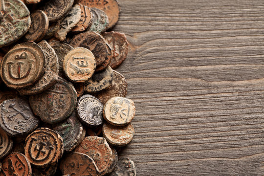 Ancient Byzantine copper coins on the old wooden table