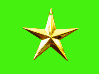 Golden five pointed star Christmas decoration for haging on tree on green background.