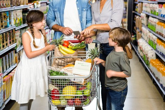 Cute family doing grocery shopping together