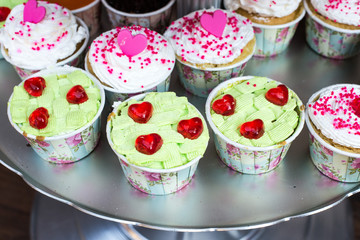 Cupcake decorated with hearts and cream