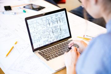 Woman engineer working on laptop