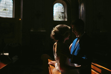 bride and groom illuminated by light