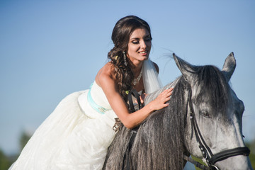 Beautiful  bride, sleeping on a horse in the nature