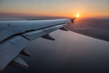 Fototapeta na wymiar airplane flight over Mediterranean Sea after evening take-off fr