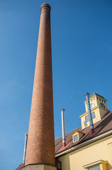 high red brick chimney in traditional brewery