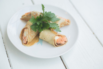 Pancakes stuffed with fish. Tasty cooked food always brings joy and pleasure . Satisfy your hunger will help in the form of snacks and sandwiches stuffed pancakes .