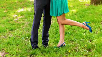 Fototapeta na wymiar Closeup portrait of a Male and female legs during a date