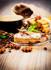 Cup of coffee and dessert on wooden background