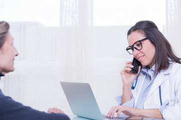 Close-up of doctor calling over phone