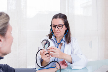 Doctor and patient measuring blood pressure