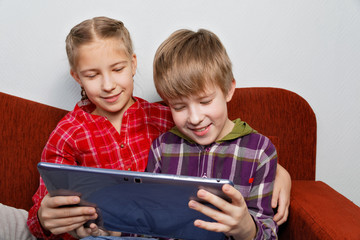 Satisfied children play on a Tablet PC