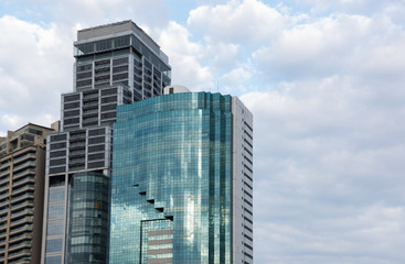 Modern glass silhouettes skyscraper against sky