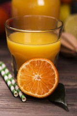 Glass of fresh homemade orange juice with pile of fruits over grunge wooden background. Selective focus-6