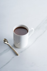 hot chocolate drink in white mug on marble table