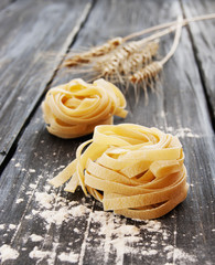 Uncooked pasta with flour on the table, selective focus