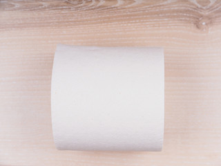 Toilet paper on wooden background