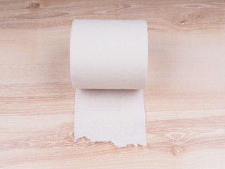 Toilet paper on wooden background
