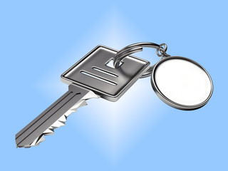 Silver keys with blank round key chain on blue background 