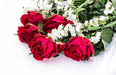 Flowers background with bouquet of red roses on white background