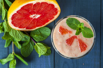 Glass of homemade smoothie with grapefruit, banana and mint leaves . Conception of healthy food.  Nonalcoholic drinks.