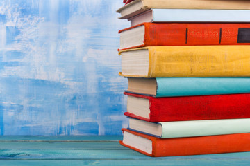 Composition with old vintage colorful hardback books, diary on w