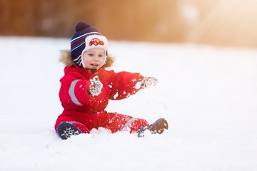 Fototapeta na wymiar Boy playing in winter landscape. Child model