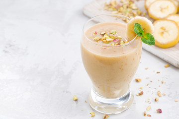 banana milkshake in a glass on white background