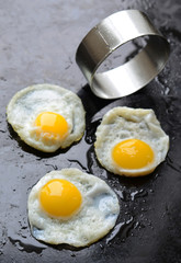 Fried eggs on black background