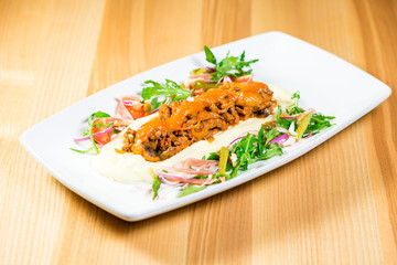 Beautiful original dish with pickles and grilled meat with a side dish of potatoes