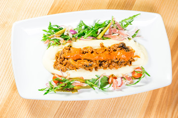 Beautiful original dish with pickles and grilled meat with a side dish of potatoes