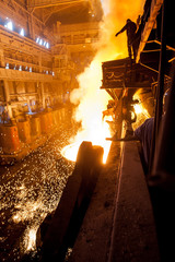 Steelworker near the tanks with hot metal