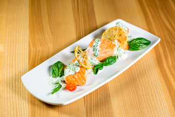 Salmon Steak with Grilled Vegetables, White Sauce and Lime