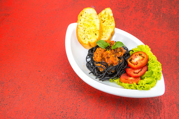 Black spaghetti the dish on the table(Selective Focus)