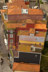 Looking Down on Clay Tile Roofs. Looking down on a triangle section of buildings on the river bank of Porto showing off the wonderful orange tiled roofs of Portugal.