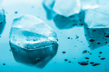 Piece of ice on the blue background  horizontal