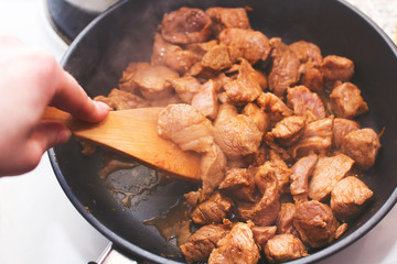 Pork fried in a pan

