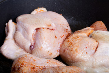 Chicken with spices fried in a pan