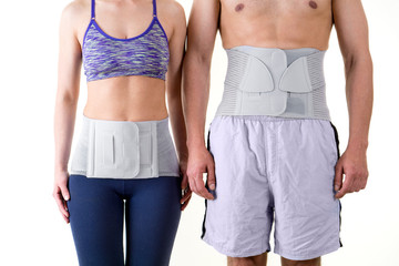 Athletic Man and Woman Wearing Back Support Braces.
