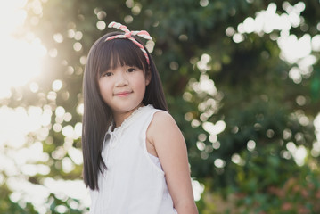 Happy little girl having fun at the park..