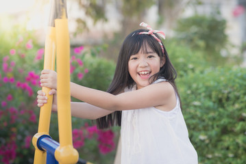 Happy little girl having fun at the park..