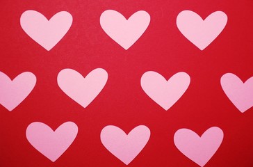 Pink hearts on a red background