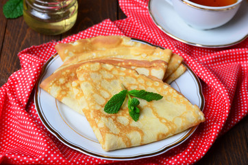 Delicious Pancakes with honey on plate 